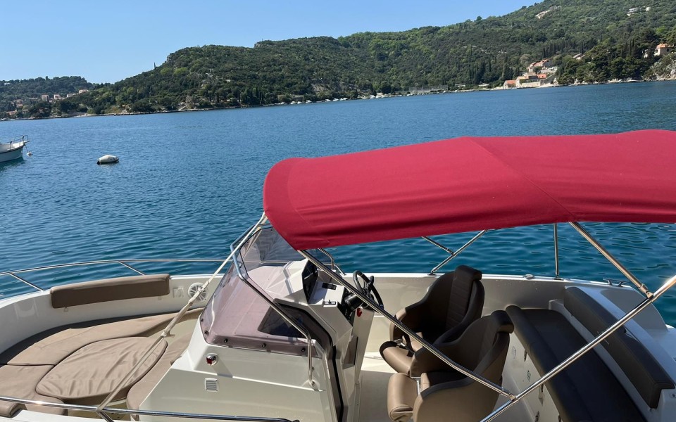 Dubrovnik day trip boat with canopy on calm bay