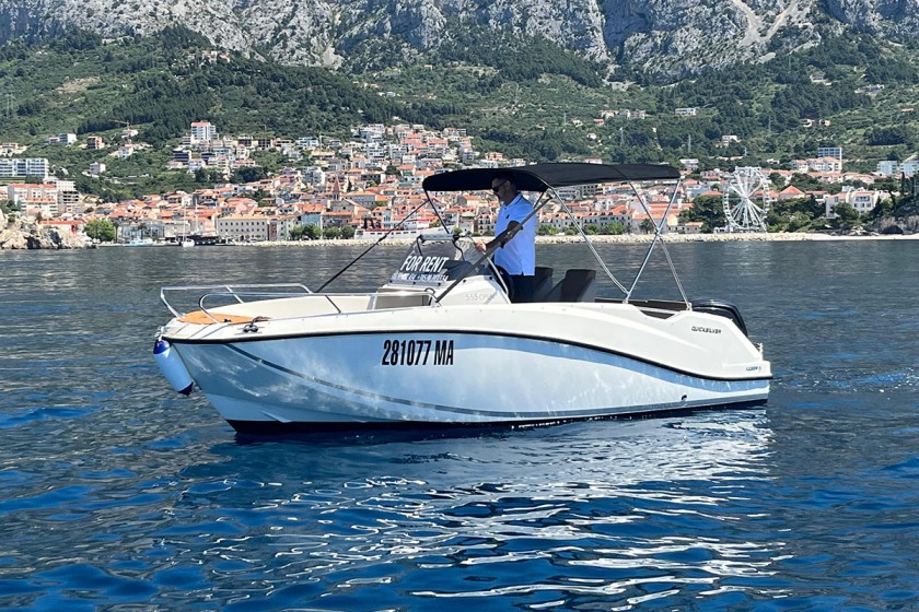 Quicksilver 555 boat cruising on the sea